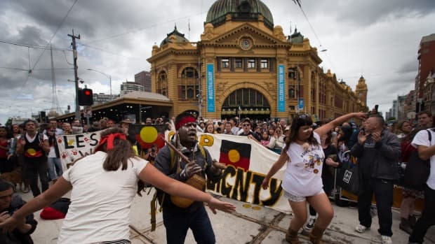 Hundreds of Invasion Day protesters march at the back of the Australian Day Parade in Melbourne's CBD. Photo: Jason South