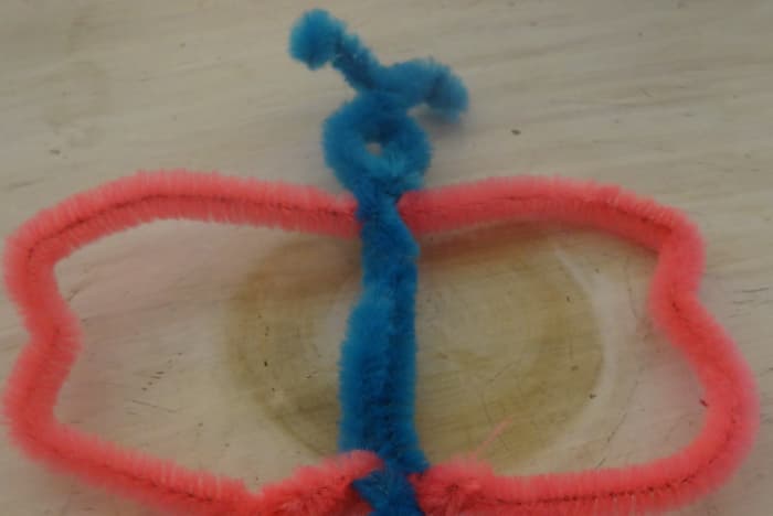 Cut any remaining pieces off the bottom, twist them together and with your fingers shape the wings so they resemble butterfly wings