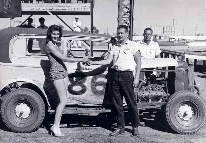 Wilbur “Willie” Berger of Newton, Kansas is shown here receiving the trophy that he was presented for winning the trophy dash at the Kansas State Fairgrounds, Labor Day 1957.