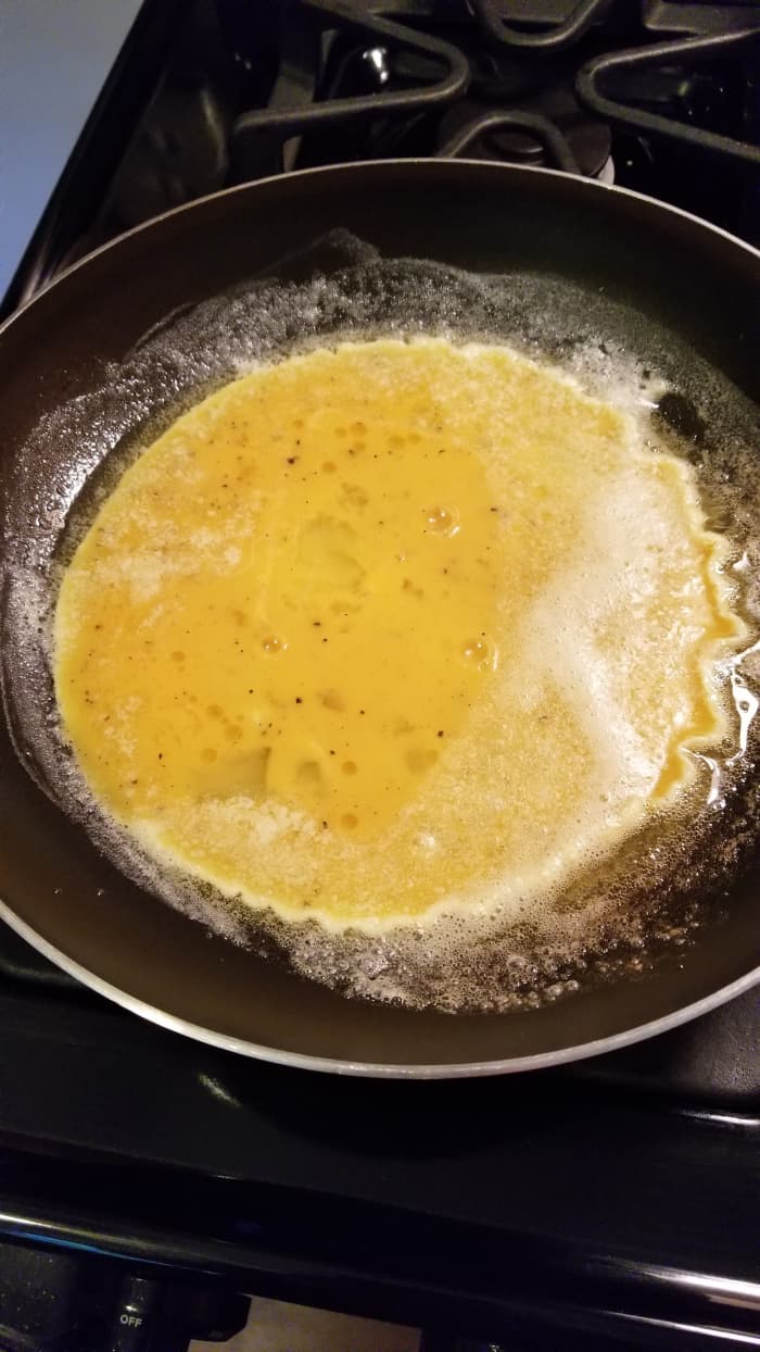 It will start to cook immediately so be sure to keep it moving! Pull those sides in and the butter will begin to incorporate into the egg mixture and add that great buttery flavor!