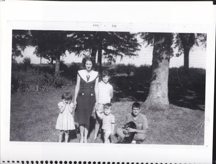 Author with mother, two sisters, and brother on front lawn of farmhouse. Taken in August 1958.