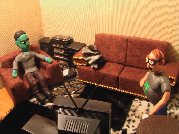 Living Room Stop-motion Set - Close up with Frankenstein and a comic book guy. Features couch, fur rug, TV, chair, stereo, table, etc.