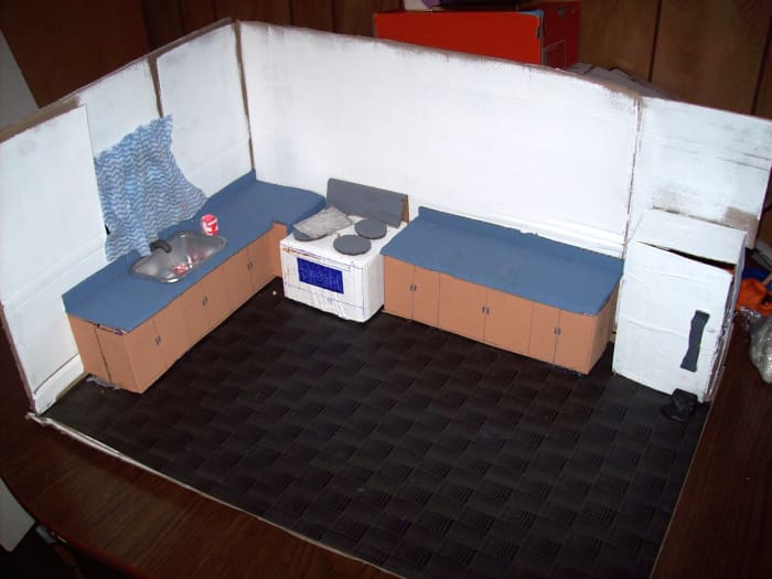 Kitchen Stop-motion Set - Includes stove, counters, sink (made of a yogurt container and painted silver), curtain (made of an old cloth), fridge. Side wall removed for easier camera shots. Although not seen back of fridge is removed for inside shots.