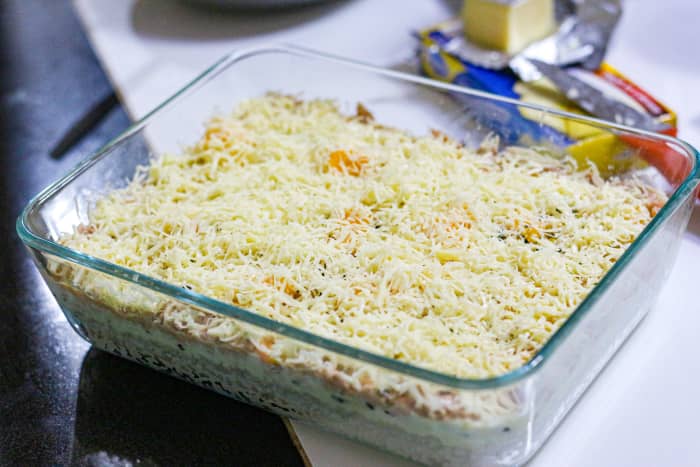 Step 4: Layer the rest of the ingredients. Spread the tuna on top of the mayonnaise mixture. Lastly, add the grated cheese.