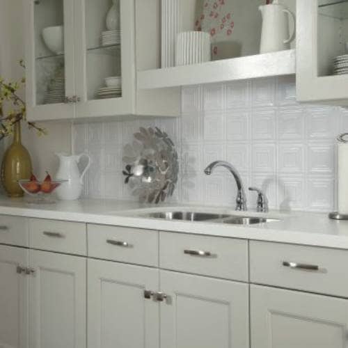 White backsplash tins are vintage styles on below the cabinets. The pressed tins are white backdrops.