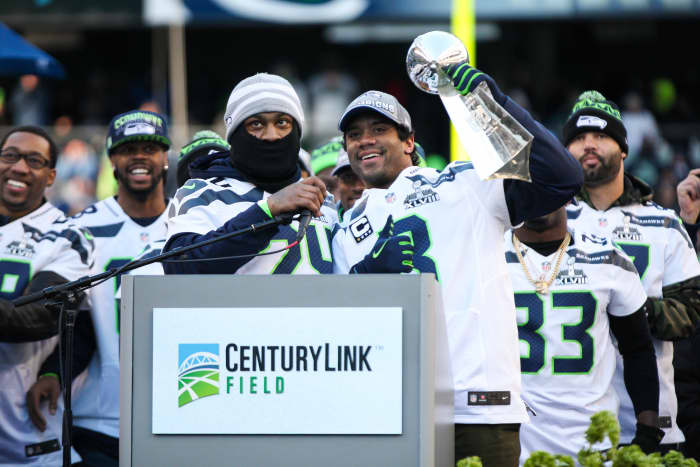 Russell Wilson (holding trophy) was a minor league baseball player within the Colorado Rockies organization.
