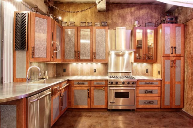 Think Steampunk for the Chinese Zodiac Rat's kitchen. There should be plenty of metal features, a rustic feel, touches of red and gold.
