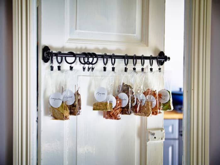 Install a rod on the kitchen door the curtain clips are on the tabs in the spices and herbs small plastic bags .