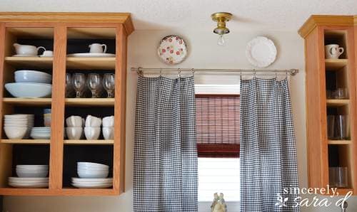 Removed the cabinet doors they added black wallpaper on the back of the cabinets. It really makes the dishes look good!
