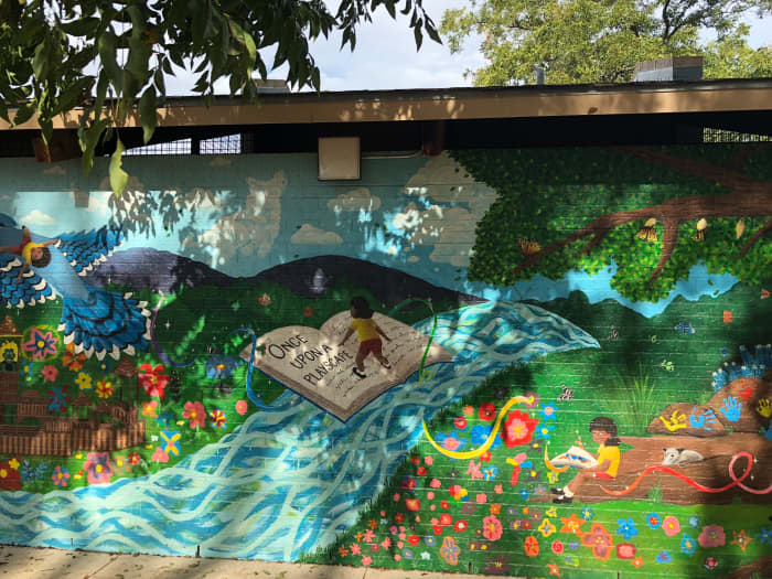 Frame 3 - Dedicates this mural to the children along with the playscape located behind the photographer.