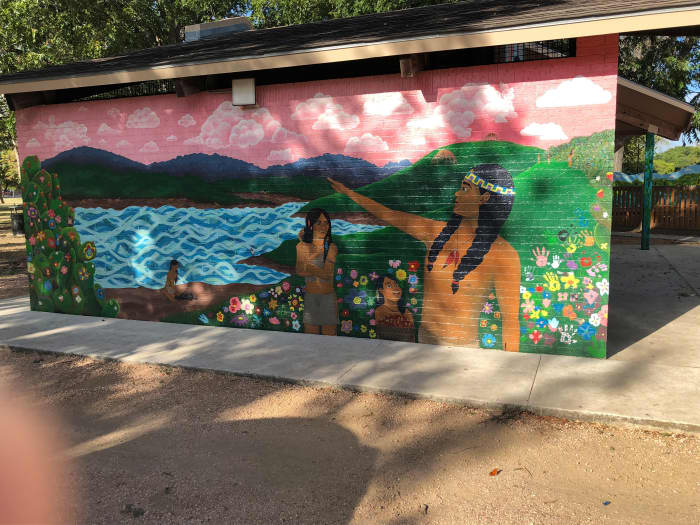 Frame 1 - A captivating mural depicting the Native American presence in the time before the founding of the City of San Marcos at the Sacred Springs, which is the head waters for the San Marcos River.