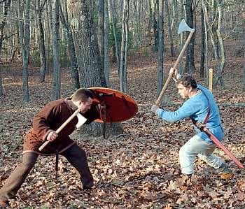 Axe combat. One man is armed with a Danish long-handled axe - these weapons could not be used easily in the shieldwall, and a man armed thus would need a comrade with shield and spear to watch his back