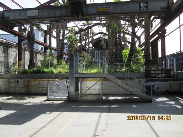 ...surprise, surprise! What was once a factory - the crane's still there - is now the approach to a salesroom for the City Island development and if you want in, the units are selling like hotcakes