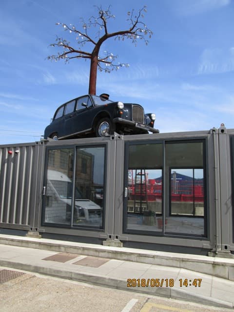 Turn the corner - hey, no wonder you can't get a cab these days, they're on top of buildings! A black cab to decorate the flat roof of a e-opening cafe/restaurant...