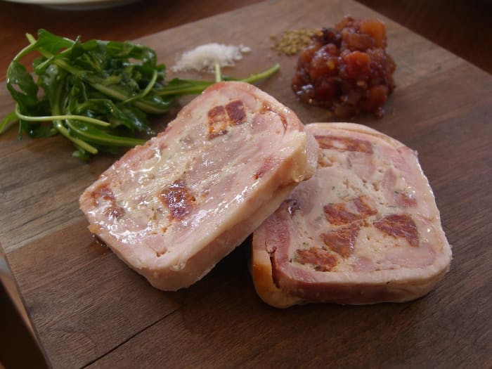 Chicken and pork terrine: a moist, delicious blend, wrapped in bacon, which may be enhanced with chunks of chorizo.