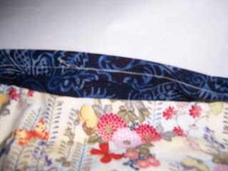 Create a tube of fabric with the seam allowance on the outside. Press and line up to the top of the back of the quilt.
