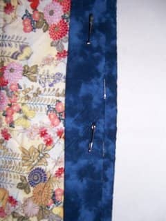 Pin the sleeve as close as you can to the binding and stitch by hand, being careful that the stitches do not show on the front of the quilt.