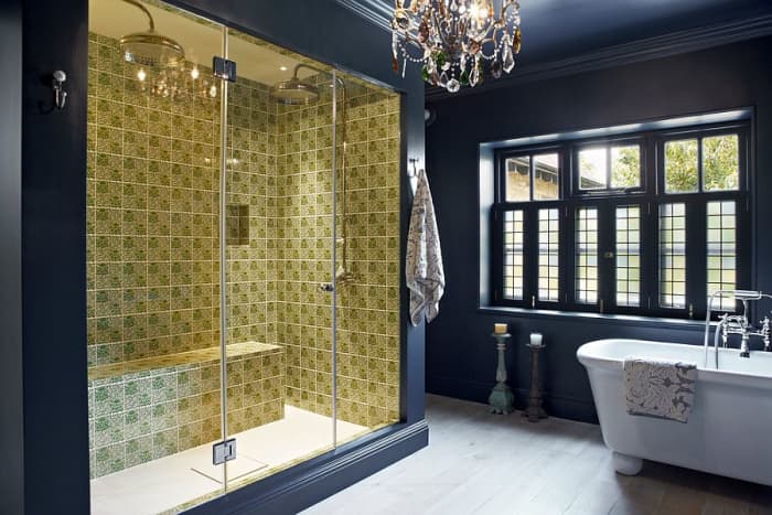This is the definition of a bathroom inspired by the Chinese Zodiac Rooster. It mixes different shapes, there is a blast of yellow, the giant glass shower doors, and the hanging chandelier.