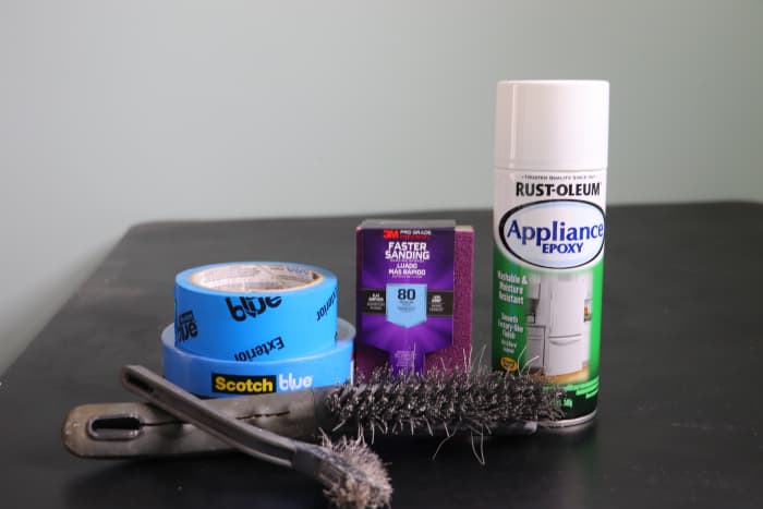 80-grit sandpaper (or a sanding sponge), wire brushes, painter's tape, and epoxy spray paint are all that are needed to make your dryer look new again!