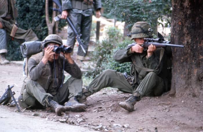 Marine sniper team searching for targets in Hue February 1968. Note in the background soldier with a bayonet on his M-16.