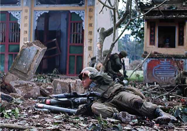 A Marine taking cover amid all the rubble by the end of the battle for Hue over 80% of the city was destroyed.