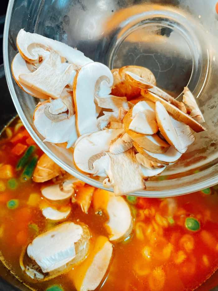 Add the sliced mushroom and the serrano peppers.