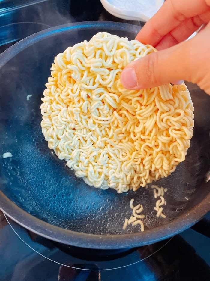 Once the water has boiled, add the ramen into the pot.