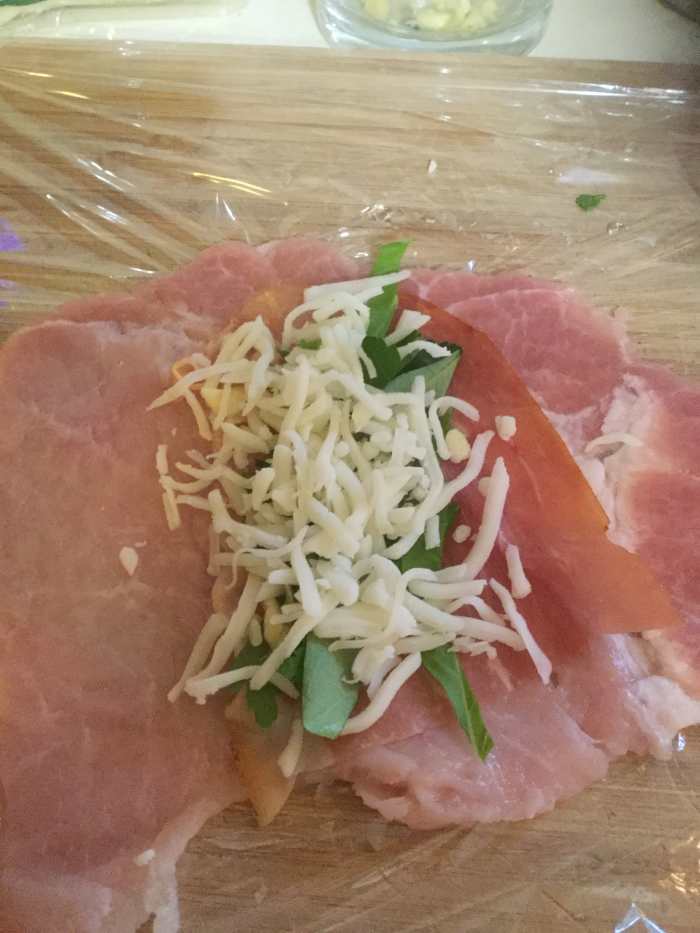 Place Chopped parsley, a few slices of Basil and Mozzarella & grated Parmagiano-Reggiano on each slice and roll tight as picture shows.