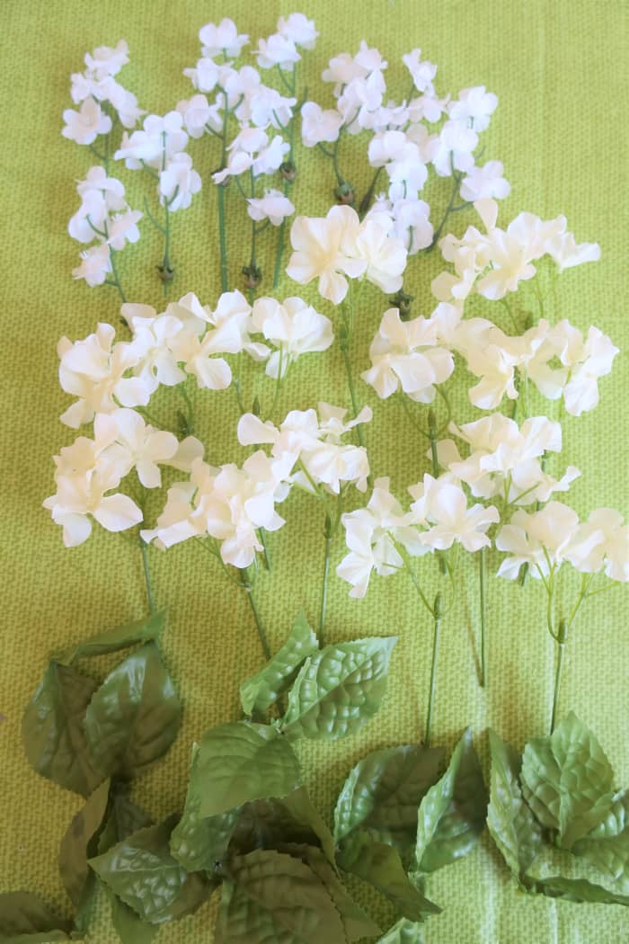 Take your artificial flowers and separate the clusters of blooms on each piece.