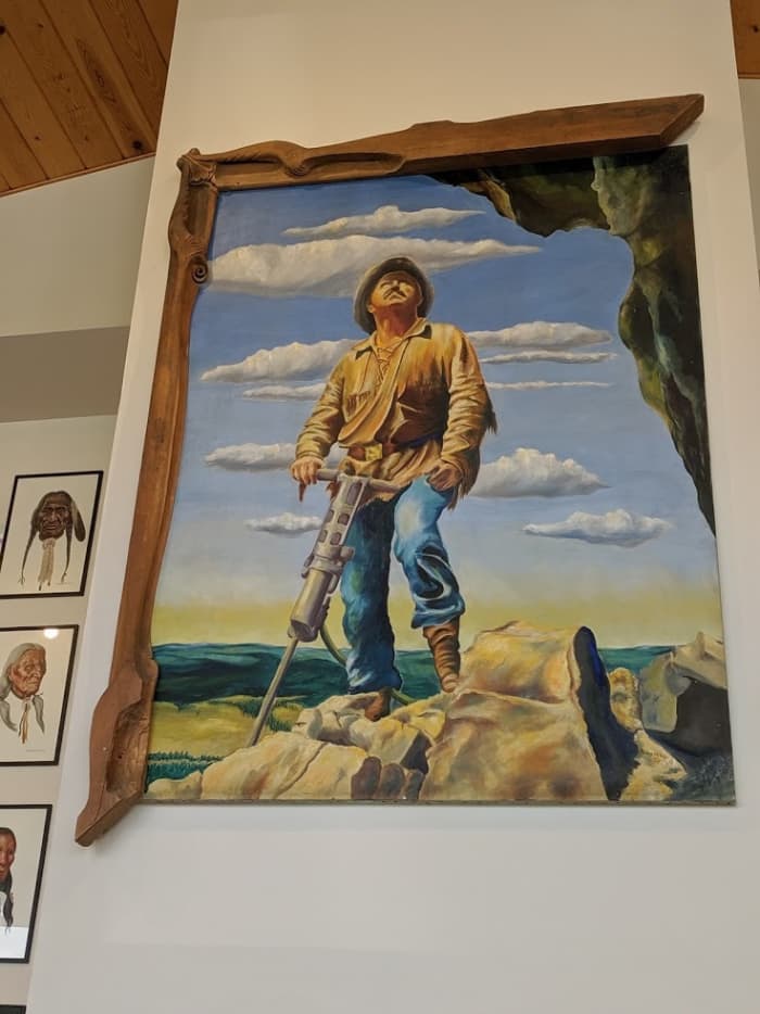 Korczak Ziolkowski working on the head of Crazy Horse painted by Dean Nauman. Korczak made a frame but only framed half, with the other half to be added when the memorial is finished.