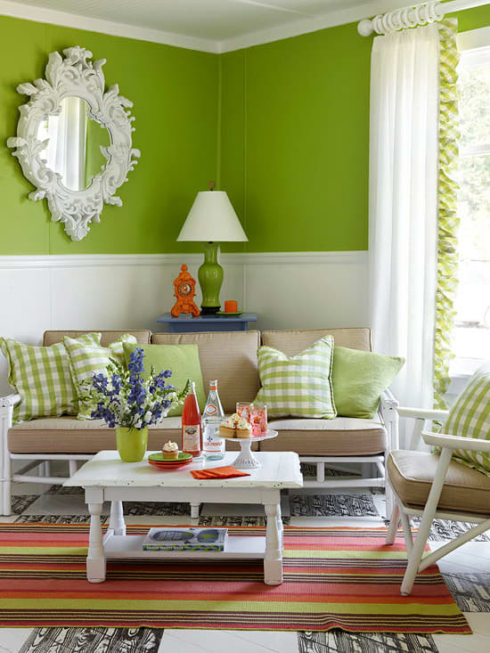 Here, a apple green sofa and bright pillows pack a punch. The rug stripe orange, brown, green and pinks adds a feminine touch to the classic furnishings.