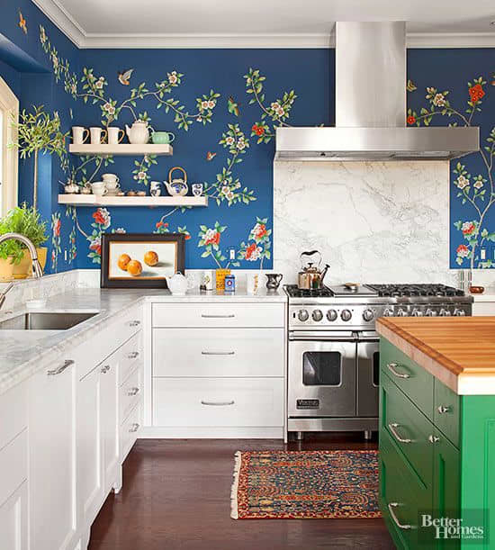 Make a statement with garden-themed kitchen wallpaper designs. The light blue backdrop is traditional white cabinetry, granite countertops and open upper shelves.