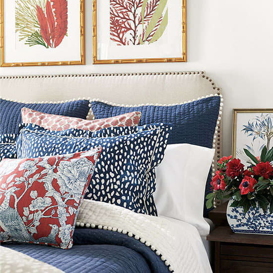 The bold bedroom in white, blue and red colors! The the furniture and linen tufted headboard and the sides.
