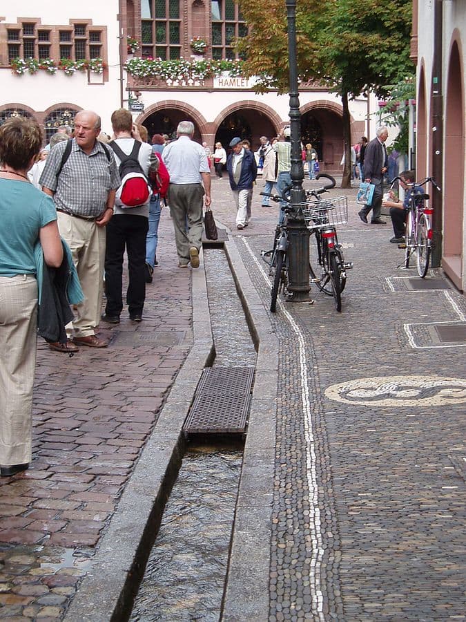Rainwater runoff runs through channels in the streets of Freiburg.