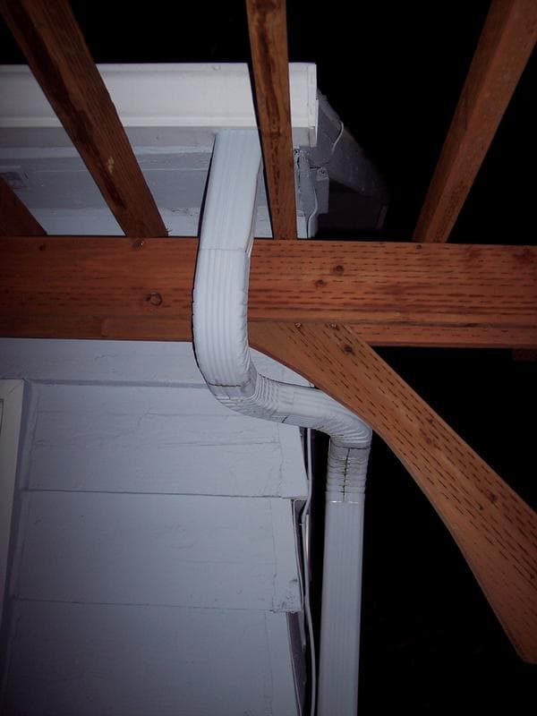 You may find that you have to re-route or relocate a few details.... Such as this gutter down spout. Because I built the pergola right up under the eaves of the house, I had to re-route this roof downspout around the beams. I used a couple of 90-deg