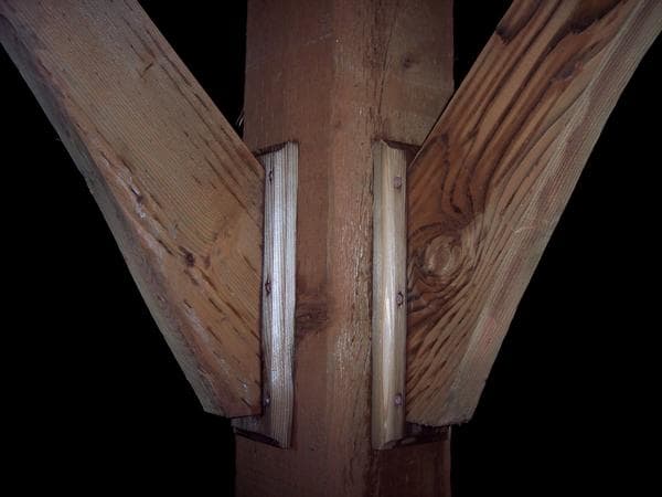 These "shoes" that hold the braces up are also 2x6 cedar decking. There are three screws in the back of the shoes directly into the braces, then we put them up and screwed them onto the 6x6. The router gives them a little shape.