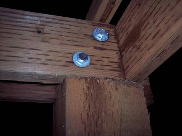 I decided to build a double 2x6 beam across the top and instead of using lag or wood screws to support it, I notched the 6x6's such that the 2x6's set on top of the 6x6.