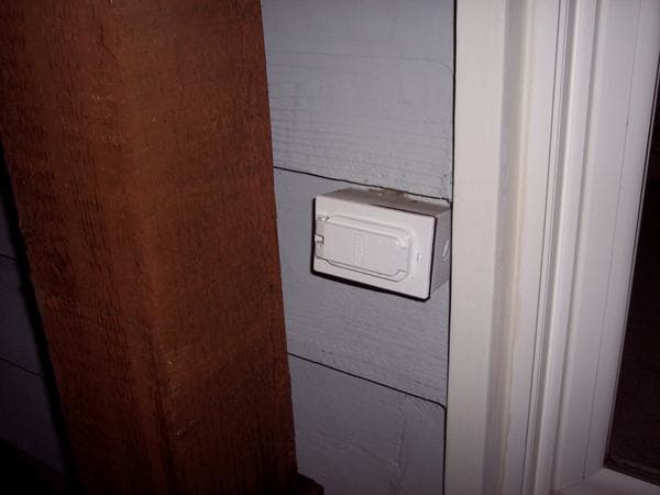While we were at it, there was an outlet directly behind this wall. I drilled through to the outlet box and added this weather-proof exterior outlet by the door. You never know when you'll need to plug a skill saw in outside!