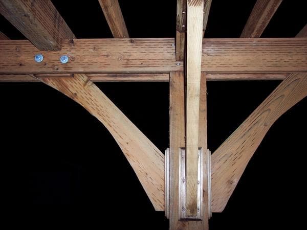 The most basic stable structure is a triangle, a lesson I will never forget from our college "bridge building" contest (another story). So for this project, we cut some 2x12's into an arch shape and I fastened them between the 2x6 beams to form trian