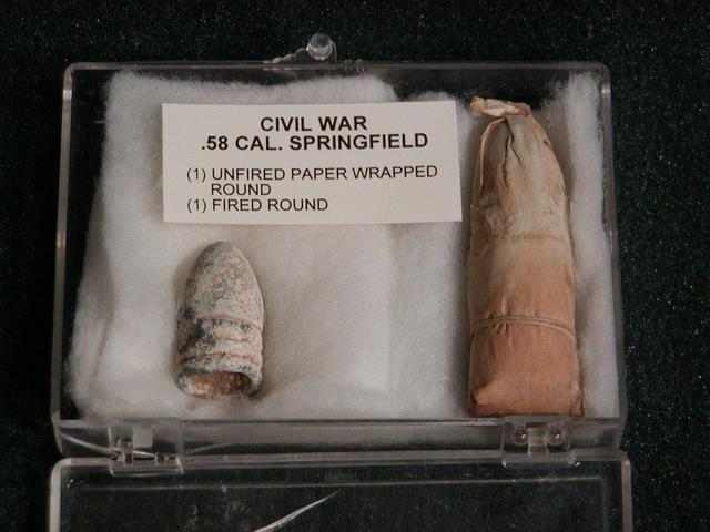 A fired Minie ball (right) and an unfired round (left.) The Minie ball could be easily pushed down the rifled barel of a gun and would expand once it fired to "catch" the rifling and become more accurate.