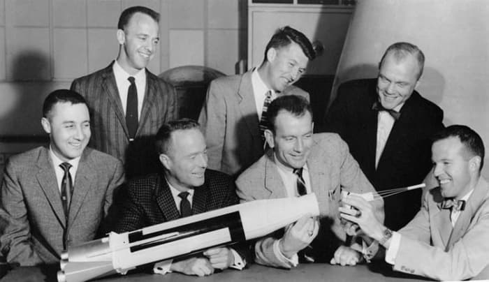 The Mercury 7 Astronauts pose with a model Atlas rocket 7/12/1962. Front Row, left to right: Gus Grissom, Scott Carpenter, Deke Slayton and Gordon Cooper. Back Row: Alan Shepard, Wally Schirra and John Glenn.