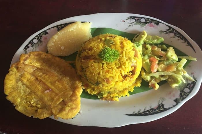 Fish Rice With Salad And Patacon (Fried Smashed Green Plantain). This dish is made with salted, dried mullet.