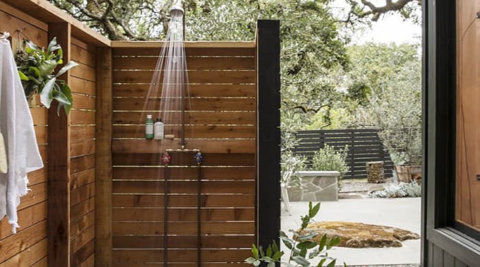 When the wood slat shower like this open-air version. Take a moment to consider your shower. Here, a wood teak behind the pipes makes for a shelf for soap and shampoo.