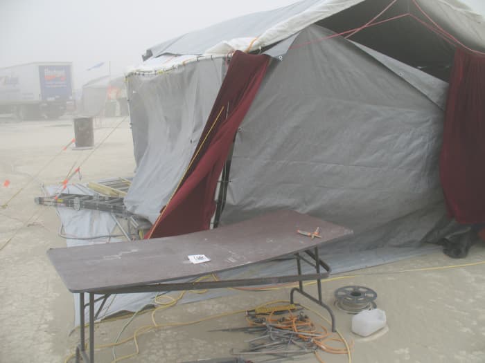 The wind in the Black Rock Desert can rip apart anything. Looks like this camp was hit before they could completely secure themselves. Get set up quickly to avoid damage.