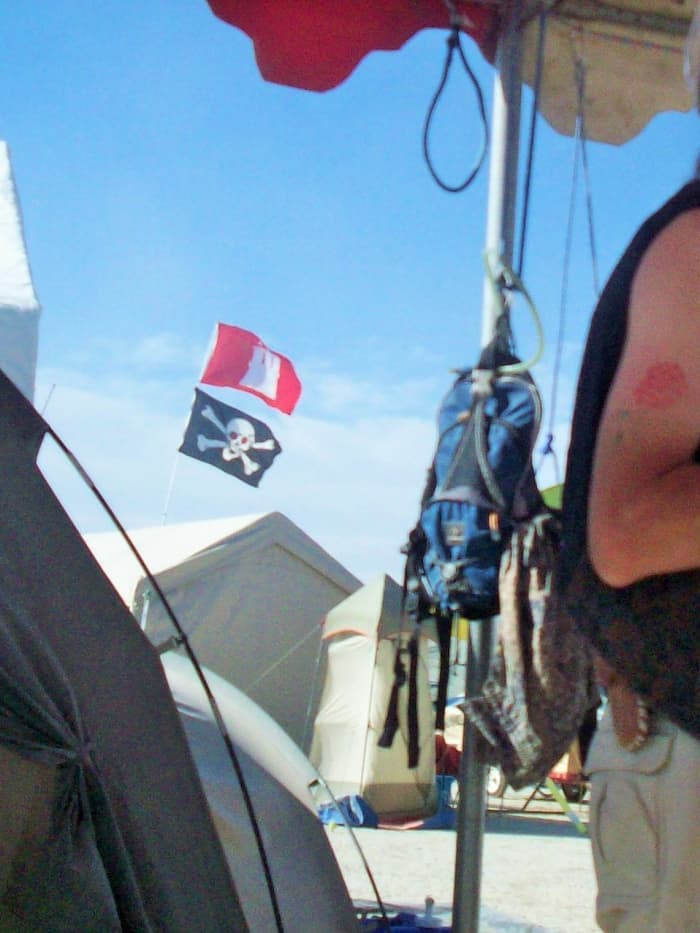 One backpack hanging off the ground at camp, with another bungee hanger available for another backpack.