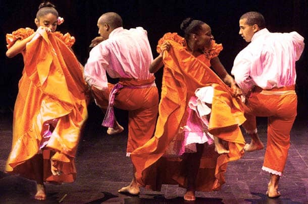 "Festejo Ritmo dancers bare-footed, jumping foot to foot, shake shoulders and spin, dance separately with energetic exuberance. This is a dance performed by Africans in Peru
