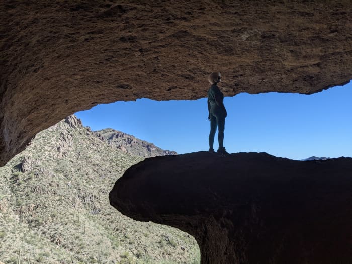 My wife standing on the rock platform at entrance to Wave Cave