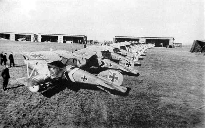 A lineup of Albatros D.III fighters of Jagdstaffel 50 - mid to late 1917. The subdued staffel scheme of black and white stripes and chevrons can be seen on the fuselage of most German figher planes, which are otherwise in factory finish.