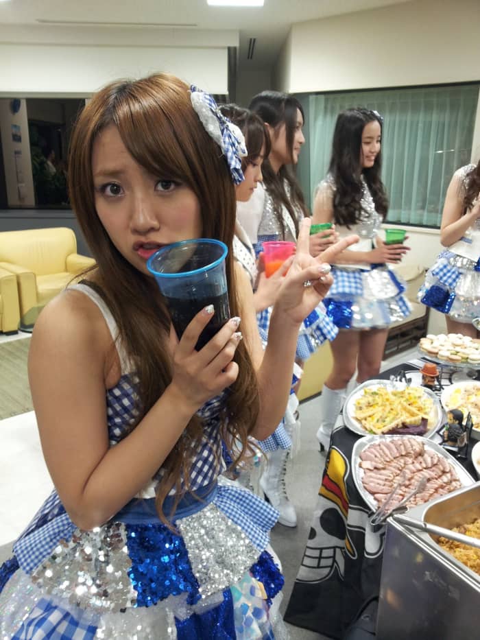 Minami Takahashi (known as Takamina) holding a soft drink in her hand and she looks like she is nervous but she is still so cute!