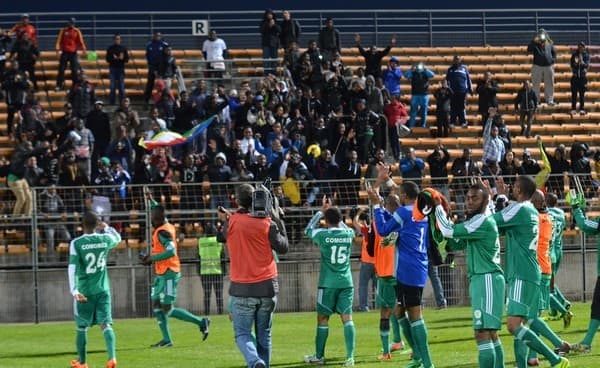 Comoran players celebrate with fans inside Stade Francis Turcan following a friendly match against Burkina Faso in 2014. The match finished 1-1 as Comoros played its first match in 15 months.